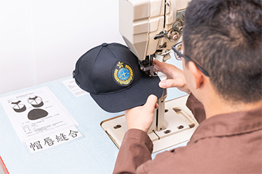 Photo 1 - Uniform caps with easy care features are produced being part of the uniform enhancement programme.
