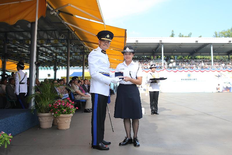 The Commissioner of Correctional Services, Mr Yau Chi-chiu (left), presents a Best Recruit Award, the Golden Whistle, to Assistant Officer II Miss Chan Pui-hang at the Passing-out cum Commissioner's Farewell Parade of the Correctional Services Department at its Staff Training Institute in Stanley today (August 18).