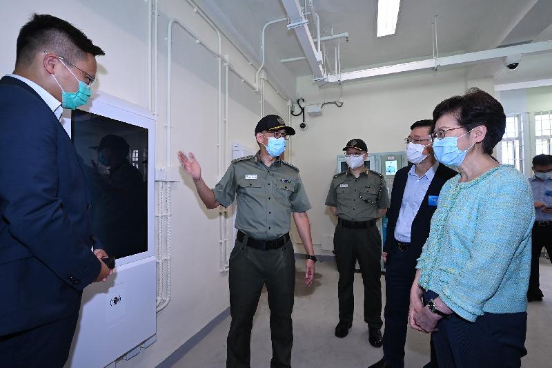 The Chief Executive, Mrs Carrie Lam, officiated at the "Smart Prison" launching ceremony at Tai Tam Gap Correctional Institution of the Correctional Services Department today (May 22). Photo shows Mrs Lam (first right) and the Secretary for Security, Mr John Lee (second right), being briefed by the Commissioner of Correctional Services, Mr Woo Ying-ming (second left), on the Persons in Custody Self-service Kiosk System, which can be used for making information enquiries and submitting requests.