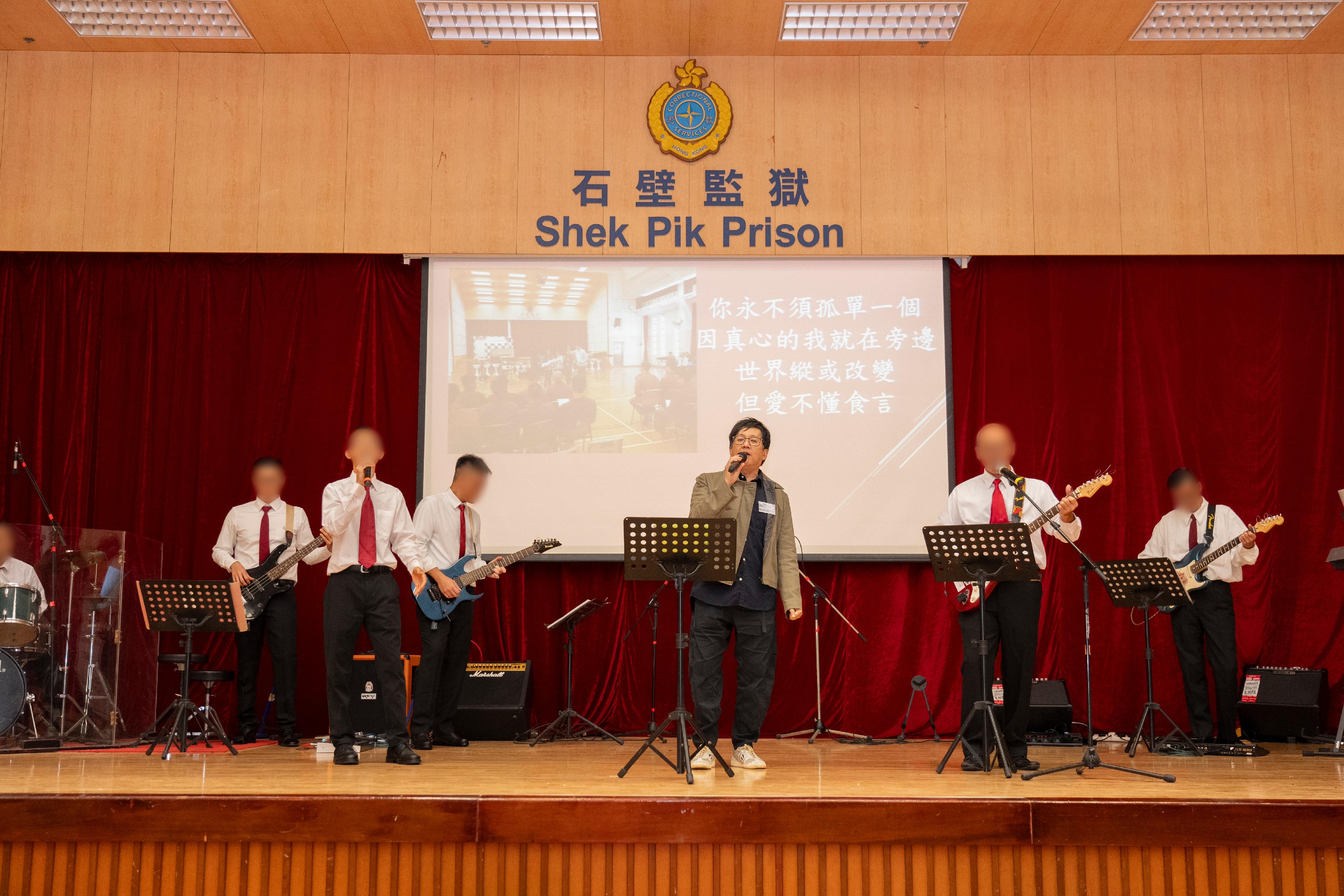 Persons in custody at Shek Pik Prison of the Correctional Services Department were presented with certificates at a ceremony today (November 23) in recognition of their study efforts and academic achievements. Photo shows renowned singer Anthony Lun (third right) partnering with persons in custody to perform live music onstage.