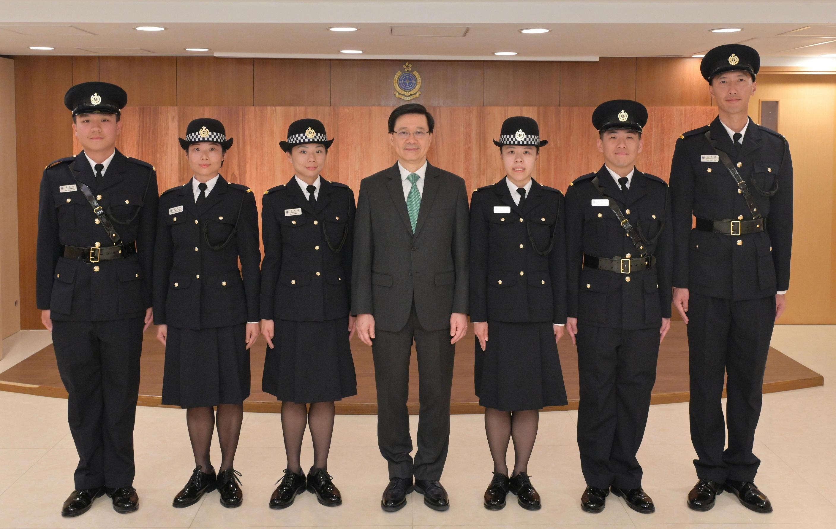 The Chief Executive, Mr John Lee, attended the Correctional Services Department passing-out parade today (November 24). Photo shows Mr Lee (centre) with the awardees of the Best Recruit Award, the Golden Whistle.