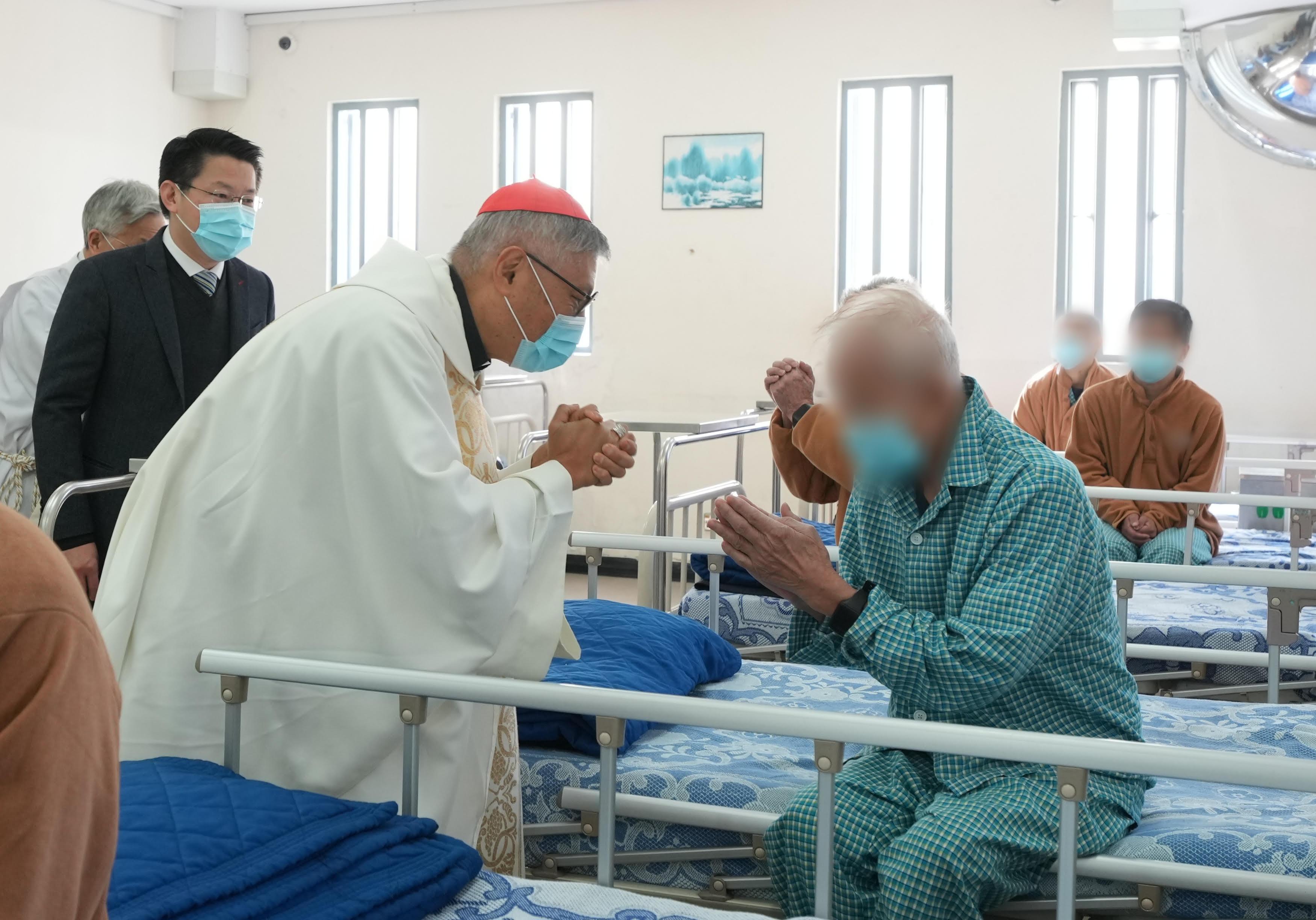 The Bishop of the Catholic Diocese of Hong Kong, Cardinal Stephen Chow (second left), accompanied by the Deputy Commissioner of Correctional Services (Operations and Strategic Development), Mr Ng Chiu-kok (first left), visited the hospital in Stanley Prison to convey his sympathy and support to the sick persons in custody today (December 25).
