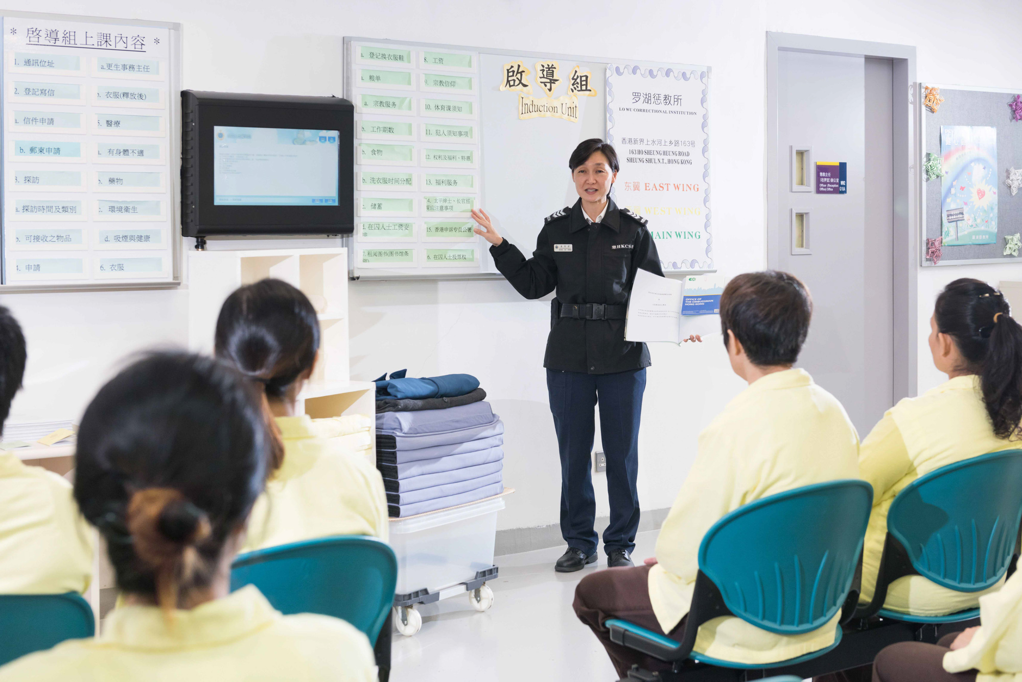 Correctional staff explain the rules, regulations, rights and complaint channels, etc. at an Induction Course for newly admitted persons in custody.