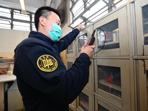 A correctional officer conducts a regular inspection in a correctional facility.