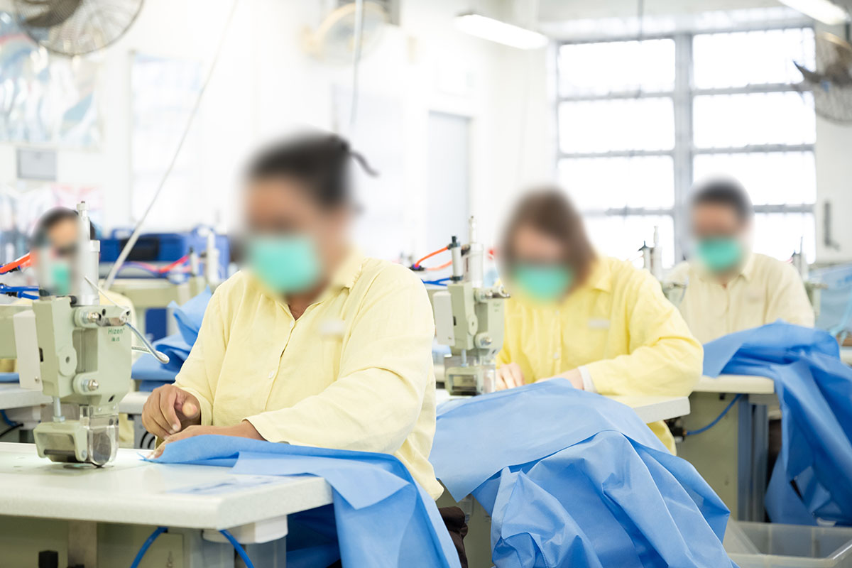 Persons in custody are engaged in the production of disposable protective gowns.