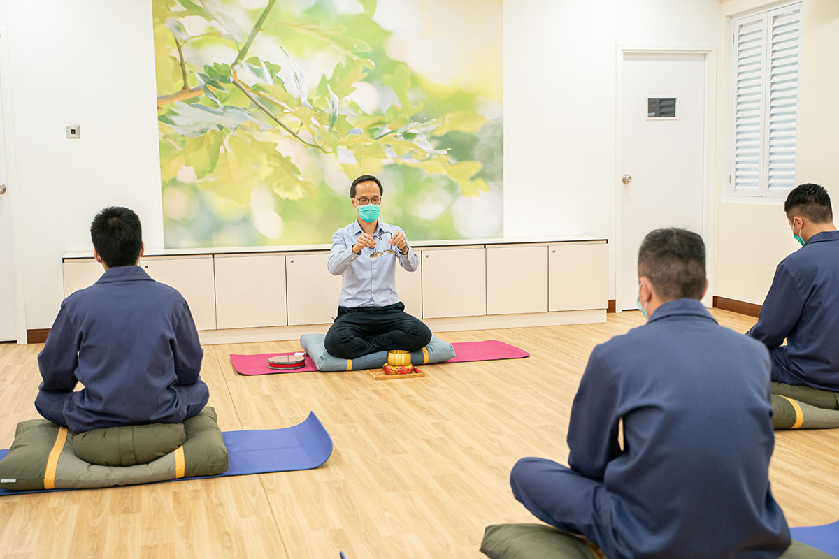 Persons in custody do mindfulness exercises.