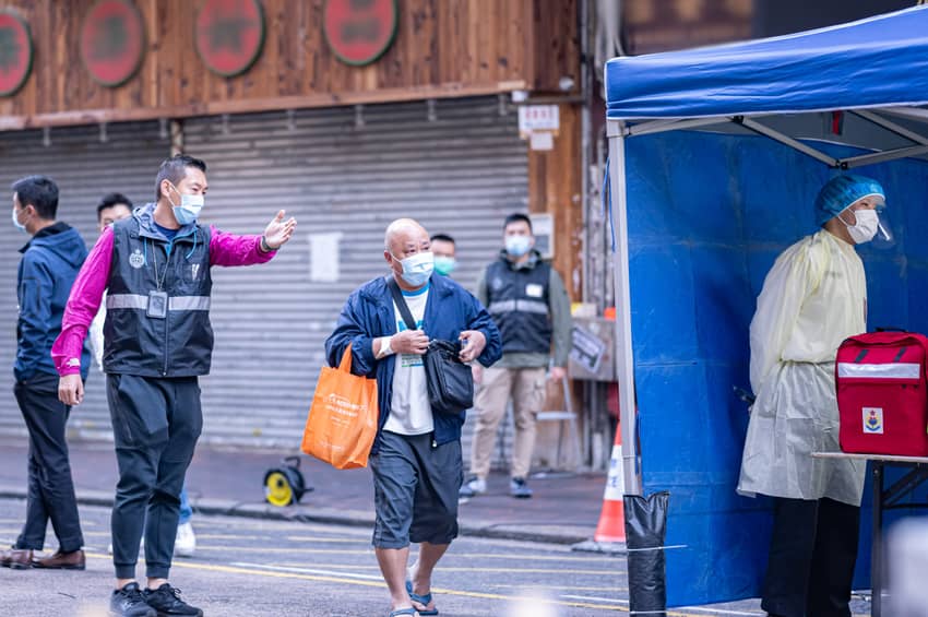 Correctional officers assist residents in undergoing testing within “restricted areas” in Jordan, Yuen Long and Sham Shui Po.