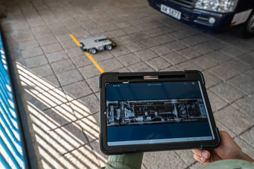 A Vehicle Chassis Inspection Robot performs a security check underneath a vehicle.
