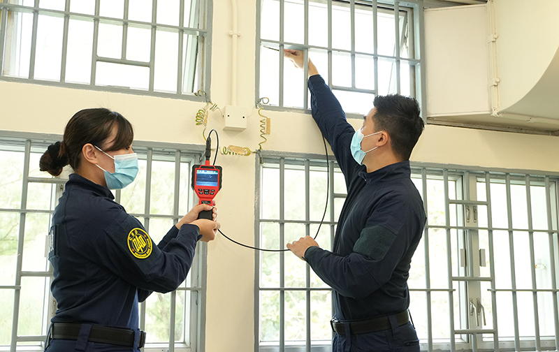 Correctional officers demonstrate how to search the contraband concealed by persons in custody at the press briefing.