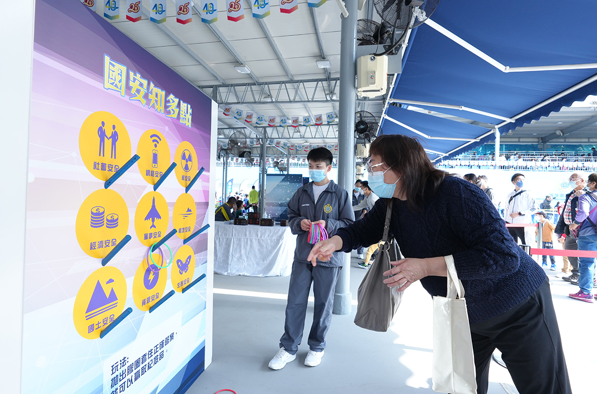 A member of the public plays at a game booth in the Grand Performance cum Open Day under the theme of “Home, Country and Correction”.