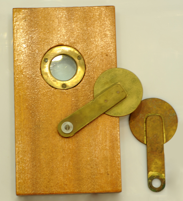 Model of a supervisory door hole and supervisory door hole cover (original) on all cell doors of Stanley Prison in the early days.