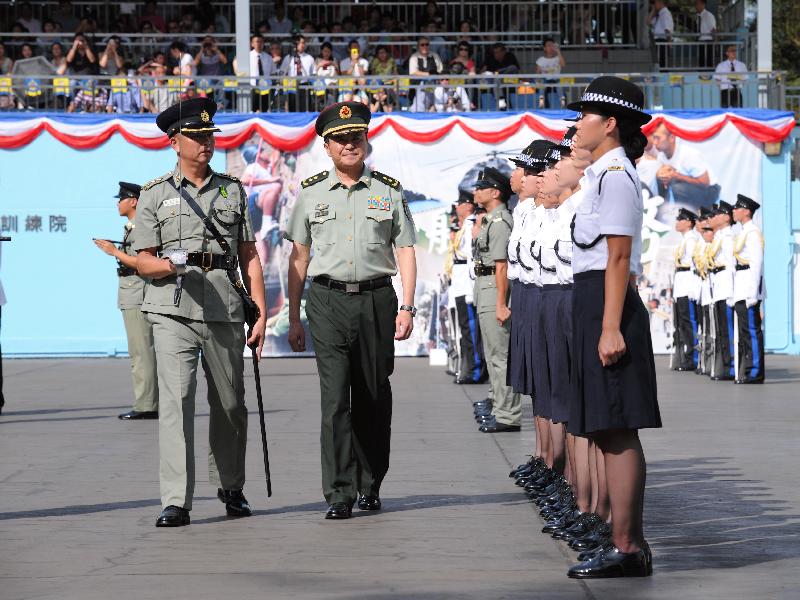 Mr Wang (centre) inspects a contingent of correctional officers at the passing-out parade at the Staff Training Institute of the CSD.