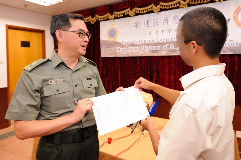 The Superintendent of Cape Collinson Correctional Institution, Mr Liu Yuen-kwong, today (July 14) presents an examination certificate to a young person in custody who participated in the Hong Kong Diploma of Secondary Education Examination.