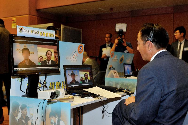 Employers conduct interviews with persons in custody in correctional institutions via computer video conferencing technology for the first time at the Job Fair for Rehabilitated Offenders 2014.