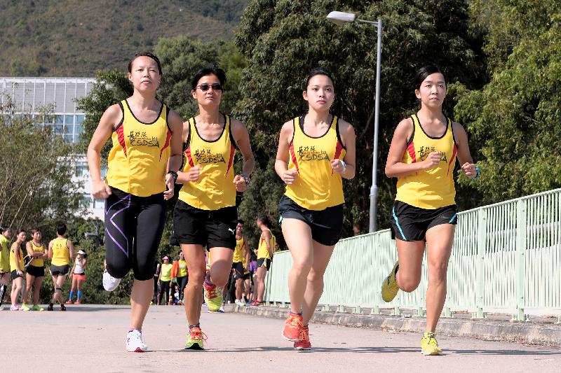 Female staff members take part in marathon training at Beas River in Sheung Shui.