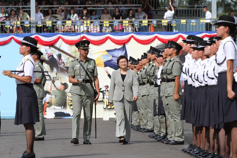 Mrs Lau (centre) inspects a contingent of correctional officers.
