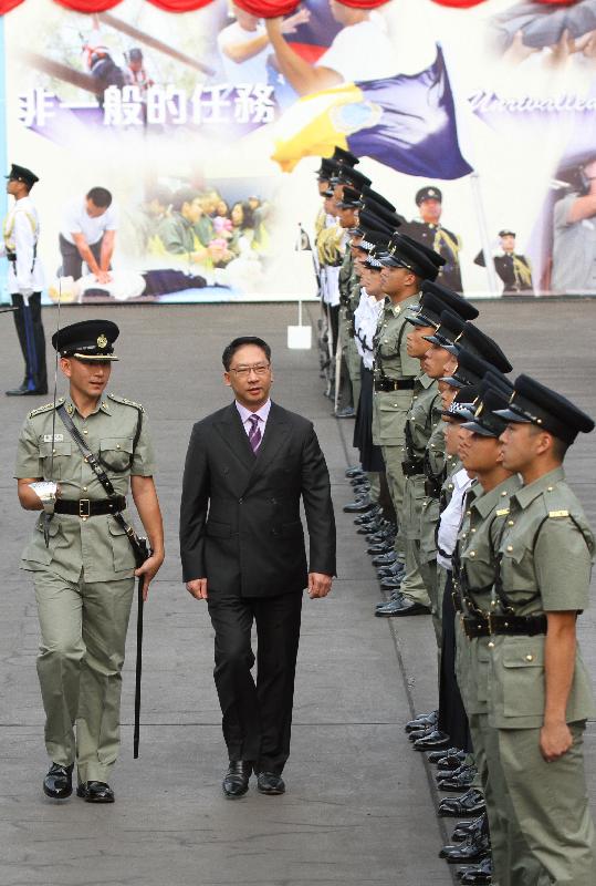 Mr Yuen (centre) inspects a contingent of correctional officers.