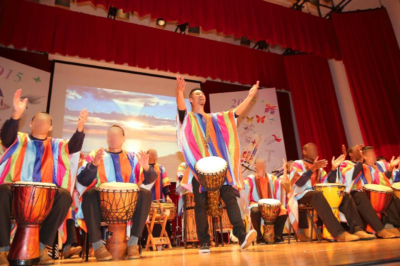 Persons in custody give an African drum performance at Stanley Prison under the guidance of instructor.