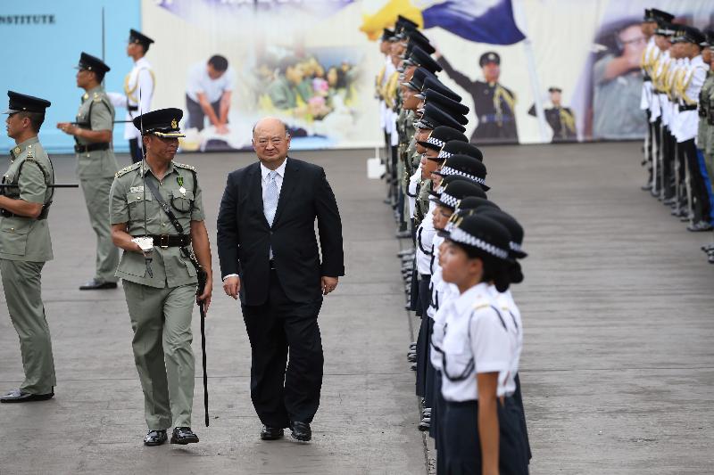 The Chief Justice of the Court of Final Appeal, Mr Geoffrey Ma Tao-li (centre), inspects a contingent of correctional officers at the Correctional Services Department (CSD) passing-out parade at the CSD's Staff Training Institute in Stanley today (June 17).