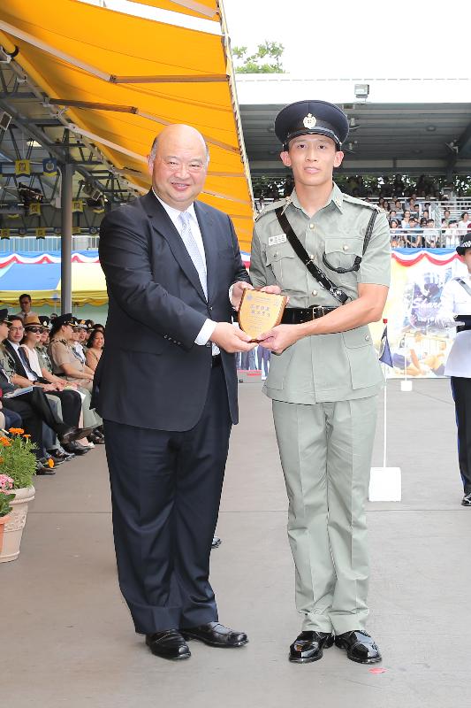 The Chief Justice of the Court of Final Appeal, Mr Geoffrey Ma Tao-li (left), presents a Best Recruit Award, the Principal's Shield, to Officer Chan Chi-ming at the Correctional Services Department (CSD) passing-out parade at the CSD's Staff Training Institute in Stanley today (June 17).