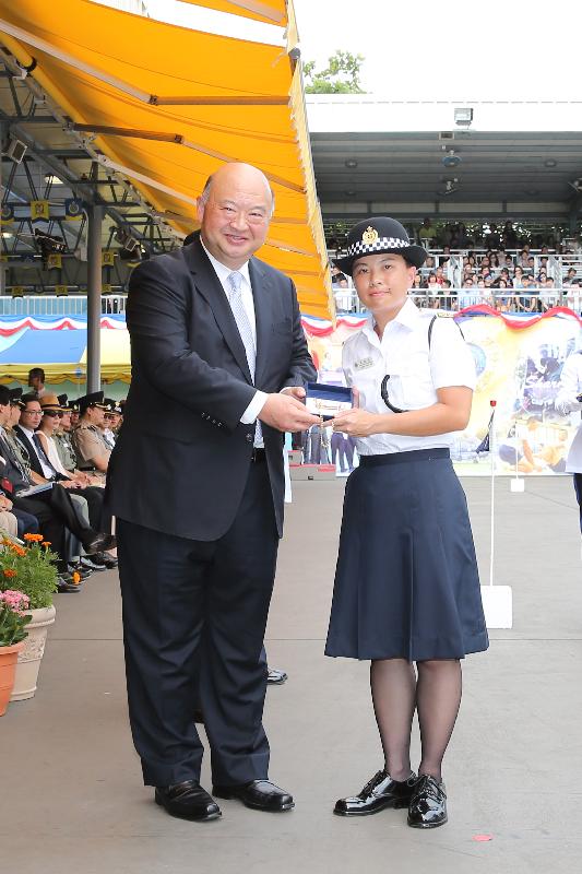 The Chief Justice of the Court of Final Appeal, Mr Geoffrey Ma Tao-li (left), presents a Best Recruit Award, the Golden Whistle, to Assistant Officer II Leung Hiu-see at the Correctional Services Department (CSD) passing-out parade at the CSD's Staff Training Institute in Stanley today (June 17).
