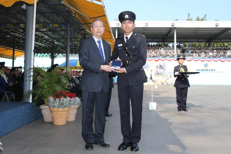 The Secretary for Security, Mr Lai Tung-kwok (left), presents a Best Recruit Award, the Golden Whistle, to Assistant Officer II Mr Sham Ka-wan at the Correctional Services Department (CSD) passing-out parade at its Staff Training Institute in Stanley today (April 28).