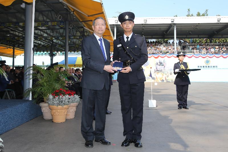 The Secretary for Security, Mr Lai Tung-kwok (left), presents a Best Recruit Award, the Golden Whistle, to Assistant Officer II Mr Chan Man-chung at the Correctional Services Department passing-out parade at its Staff Training Institute in Stanley today (April 28).