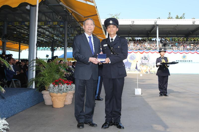 The Secretary for Security, Mr Lai Tung-kwok (left), presents a Best Recruit Award, the Golden Whistle, to Assistant Officer II Mr Cheung Ka-yiu at the Correctional Services Department passing-out parade at its Staff Training Institute in Stanley today (April 28).