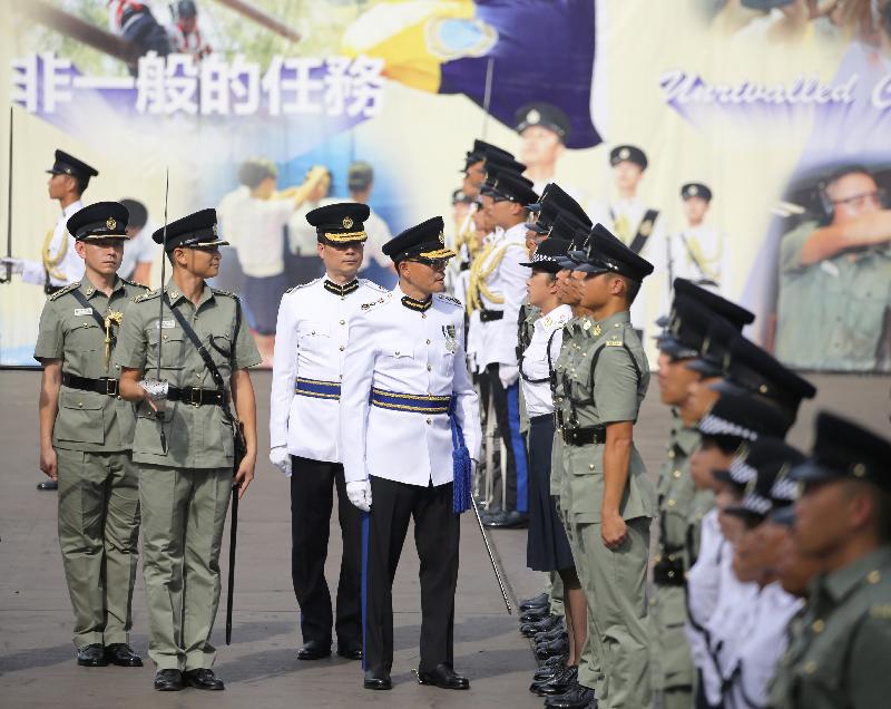 The Commissioner of Correctional Services, Mr Yau Chi-chiu (fourth left), inspects a contingent of correctional officers during the Passing-out cum Commissioner's Farewell Parade of the Correctional Services Department at its Staff Training Institute in Stanley today (August 18).