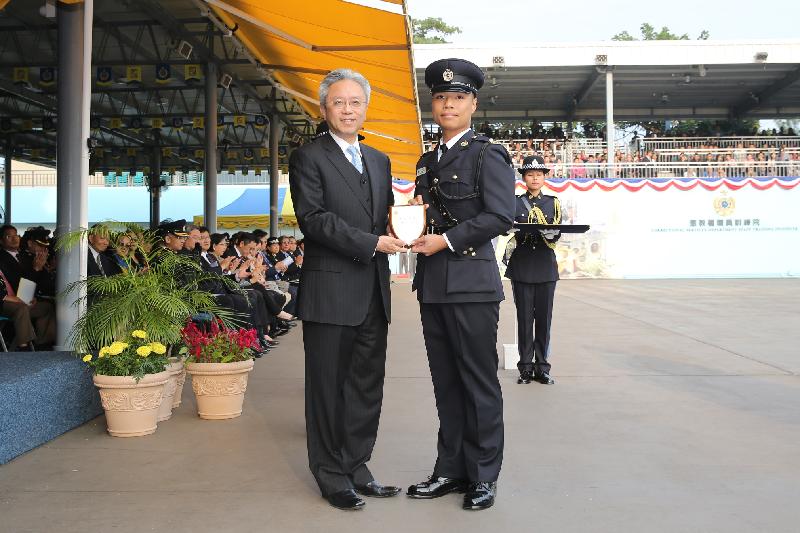 The Secretary for the Civil Service, Mr Joshua Law (left), presents a Best Recruit Award, the Principal's Shield, to Officer Mr Ng Kin-pan at the Correctional Services Department passing-out parade at its Staff Training Institute in Stanley today (December 7).