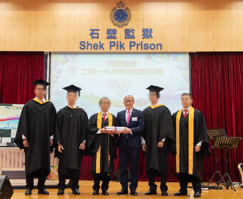 A total of 102 persons in custody in Shek Pik Prison of the Correctional Services Department were presented with scholastic certificates at a ceremony today (October 30) in recognition of their study efforts and academic achievements. Photo shows the Chairman of the Board of Directors of the Po Leung Kuk, Mr Ma Ching-nam (third right), presenting scholastic certificates to persons in custody.