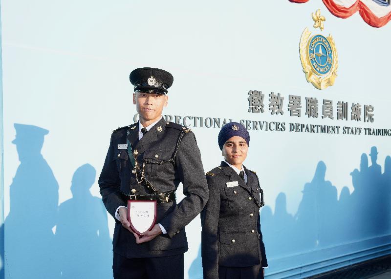 The Correctional Services Department held a passing-out parade at the Staff Training Institute in Stanley today (December 6). Photo shows the two graduates, Officer Mr Law Man-kwong (left) and Assistant Officer II Ms Kaur Sukhdeep (right).