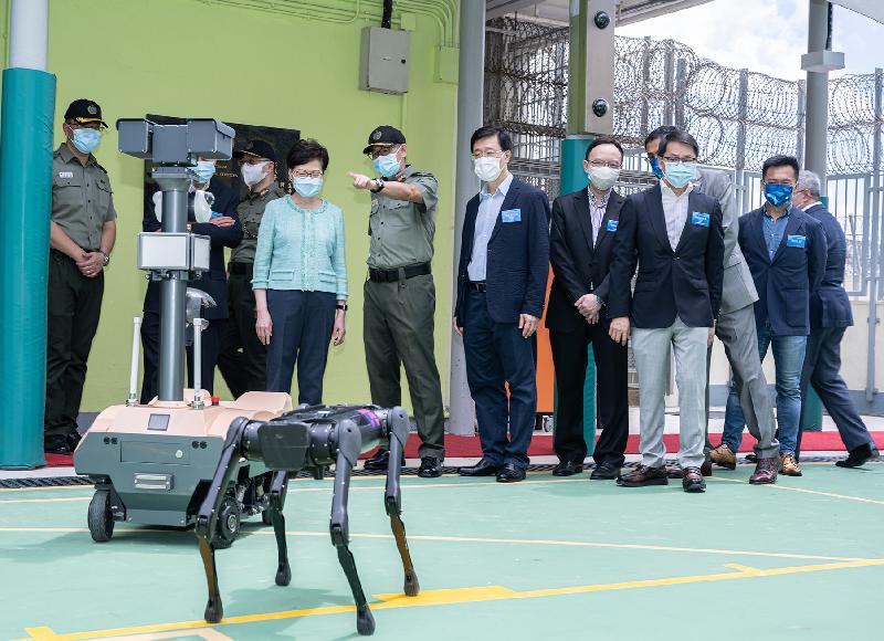 The Chief Executive, Mrs Carrie Lam, officiated at the "Smart Prison" launching ceremony at Tai Tam Gap Correctional Institution of the Correctional Services Department today (May 22). Photo shows Mrs Lam (fourth left), the Secretary for Security, Mr John Lee (sixth left), and other guests, being briefed by the Commissioner of Correctional Services, Mr Woo Ying-ming (fifth left), on the Intelligent Robotic Monitoring System to be launched for use and the Robotic Patrol Dog under development.