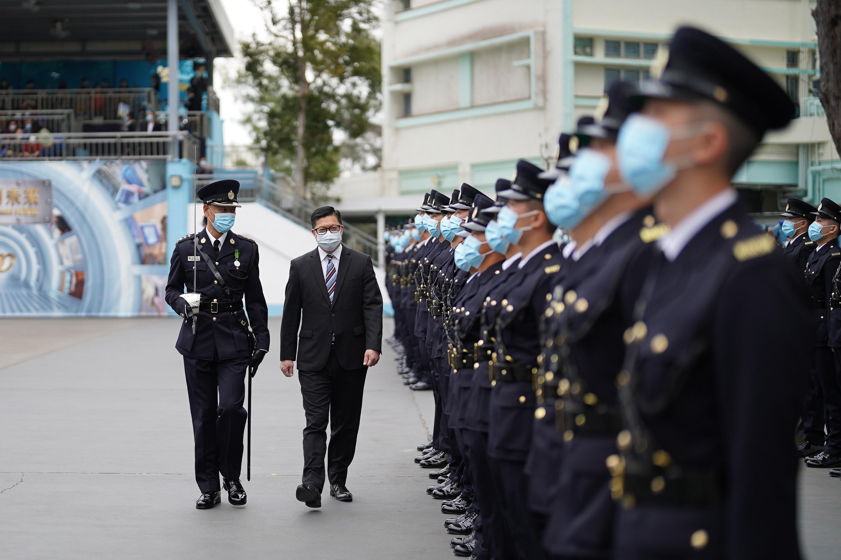 The Correctional Services Department held a passing-out parade at the Staff Training Institute in Stanley today (December 17). Photo shows the Secretary for Security, Mr Tang Ping-keung (second left), inspecting a contingent of graduates.