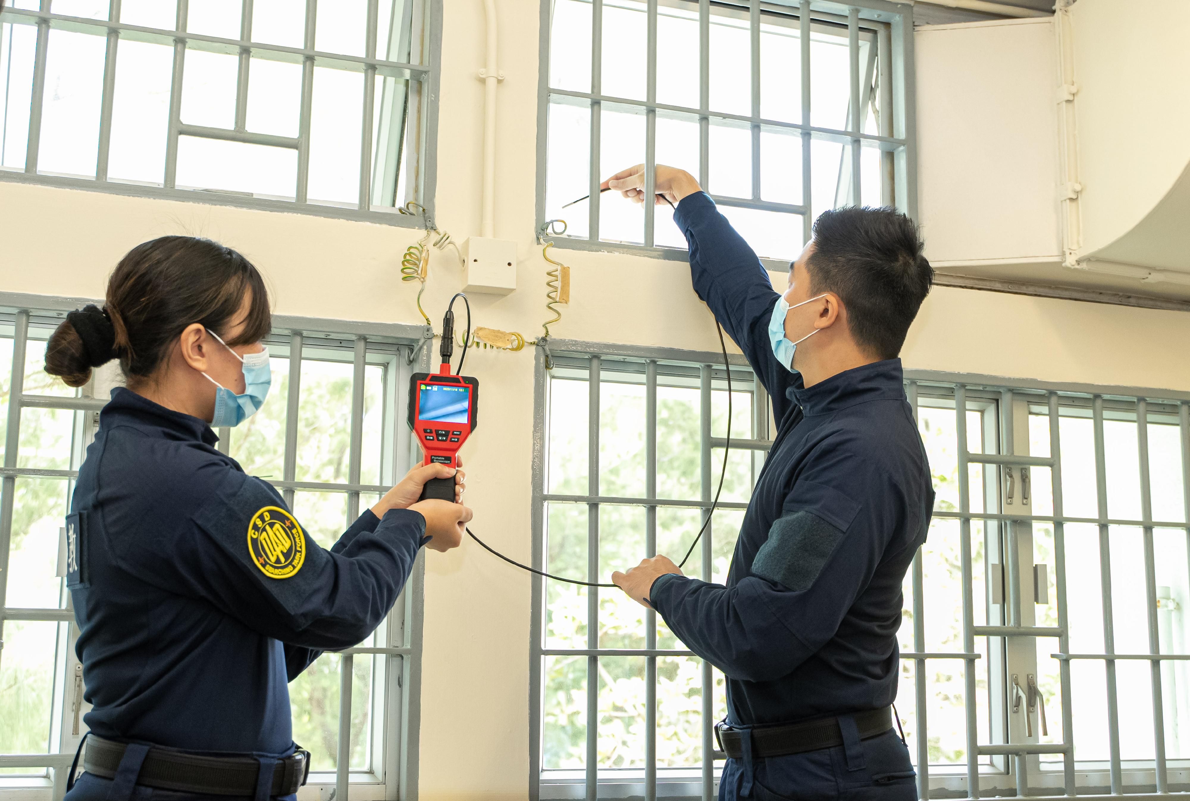 The Correctional Services Department held a press briefing on its anti-gambling operations ahead of World Cup 2022 today (November 18). Photo shows correctional officers demonstrating a search to prevent persons in custody from concealing contraband.