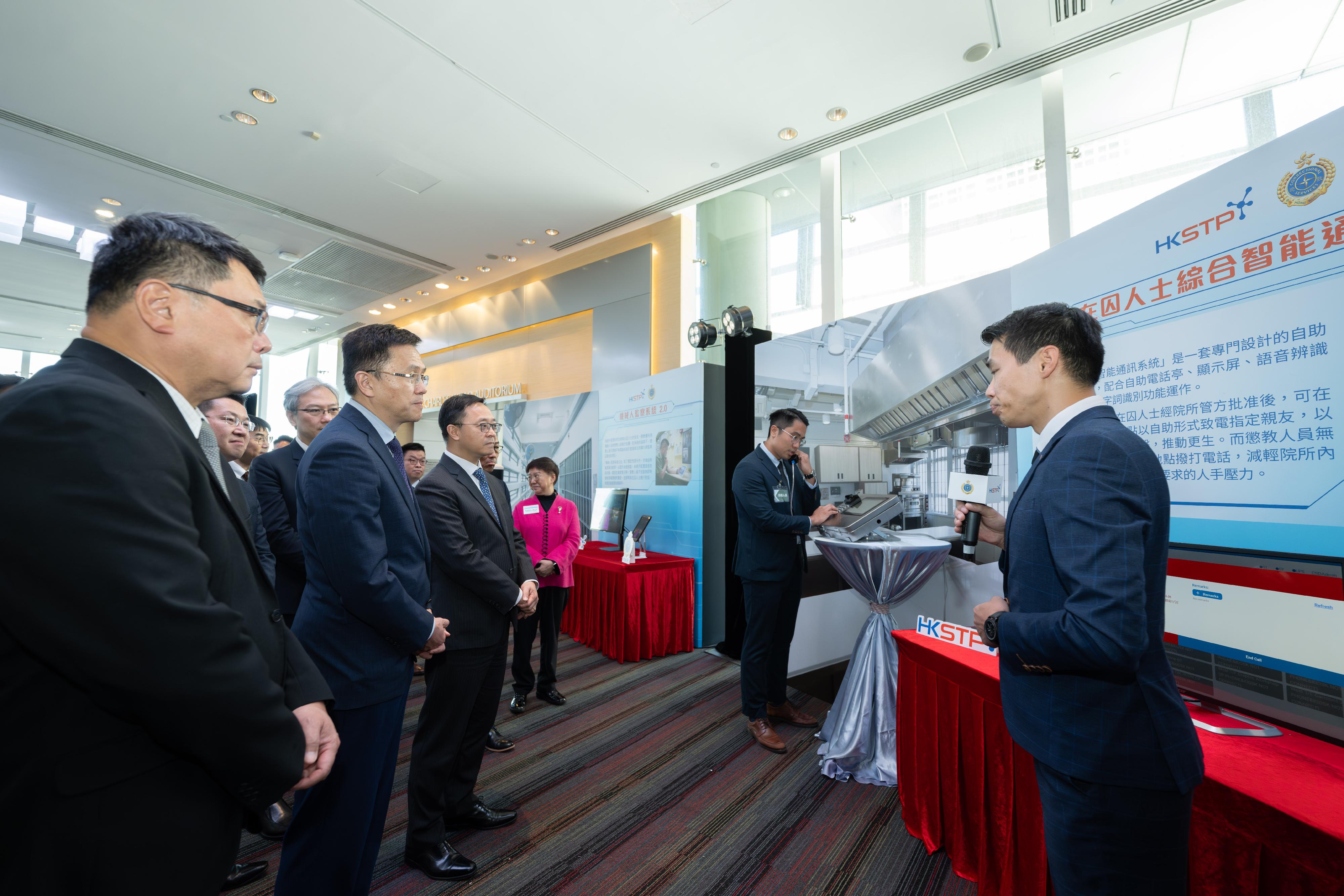 The Correctional Services Department and the Hong Kong Science and Technology Parks Corporation (HKSTP) signed a Memorandum of Understanding today (July 11) to deepen their co-operation, which will inject new impetus into the sustainable development of “Smart Prison”. Photo shows the Secretary for Innovation, Technology and Industry, Professor Sun Dong (second left), accompanied by the Commissioner of Correctional Services, Mr Wong Kwok-hing (third left), and the Chairman of the HKSTP, Dr Sunny Chai (first left), being briefed by a correctional officer, on an innovation and technology project of “Smart Prison”.