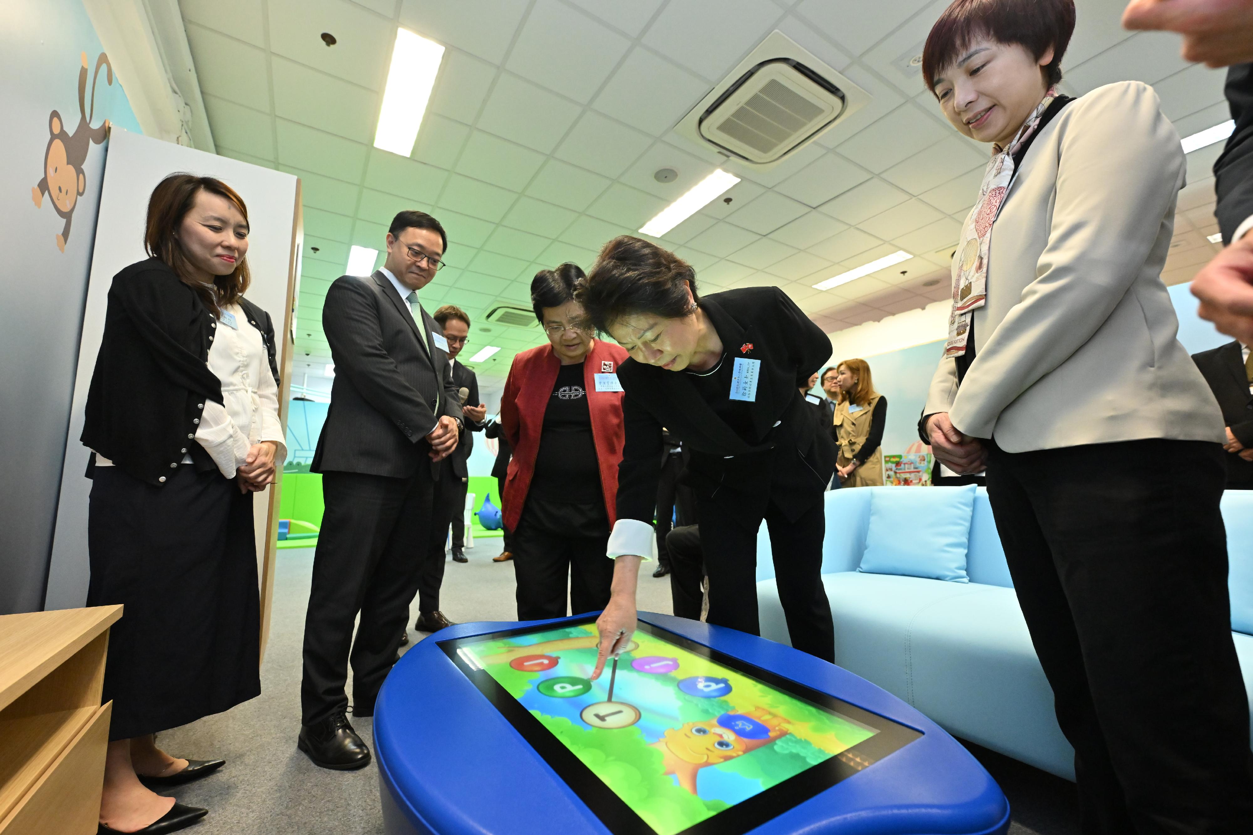 The Correctional Services Department officially launched a Parent-child Centre in Stanley Prison today (December 13). Photo shows the Chairman of the Committee on Community Support for Rehabilitated Offenders, Ms Tsui Li (second right); the Head of Charities (Youth Development & Poverty Alleviation) of the Hong Kong Jockey Club, Ms Winnie Ying (first right); the Commissioner of Correctional Services, Mr Wong Kwok-hing (second left); and other guests touring the centre.