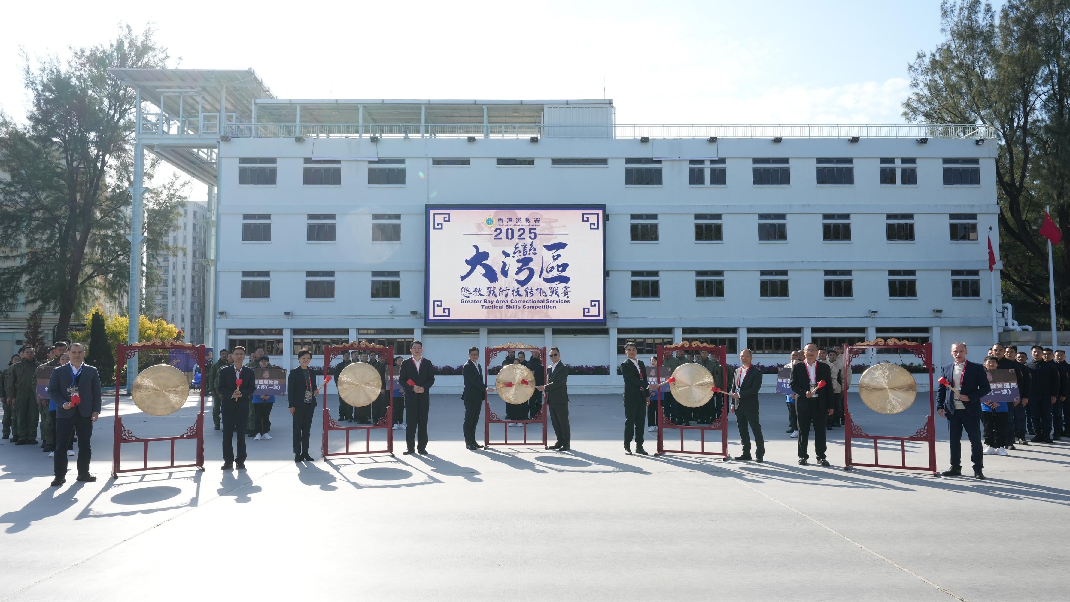 惩教署主办的首届大湾区惩教战术技能挑战赛今日（一月十三日）揭开序幕，有超过100名来自内地、澳门及香港的惩教人员参与。图示（前排左起）深圳市司法局监狱戒毒管理办公室主任林旭彬、广州市司法局副局长何友汉、中央人民政府驻香港特别行政区联络办公室警务联络部副部长孟小援、国家司法部监狱管理局局长范履冰、保安局局长邓炳强、惩教署署长黄国兴、澳门惩教管理局局长程况明、广东省监狱管理局副局长刘任求、广东司法警官职业学院党委副书记李忠源和警务处助理处长（行动）庄定贤主持开幕仪式。