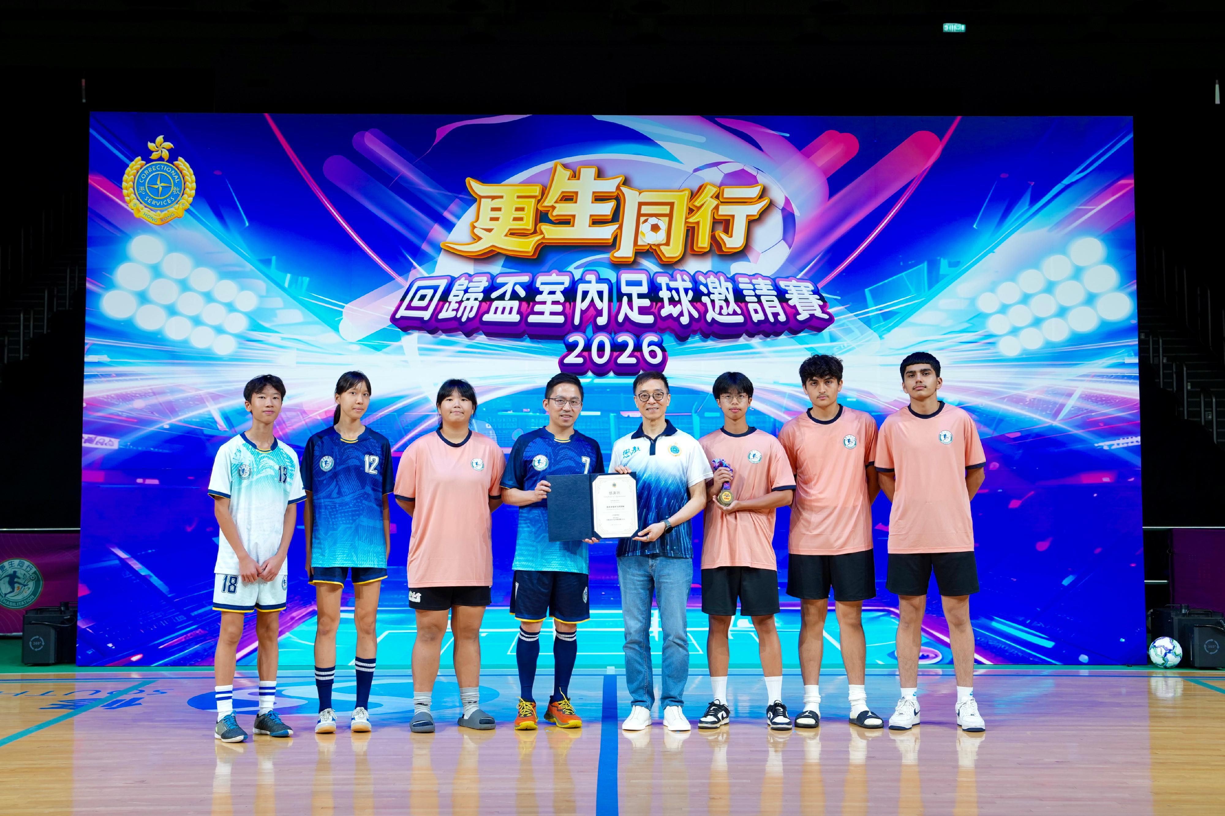 The Correctional Services Department today (June 28) held the Joining Hands on the Road to Rehabilitation &ndash; Hong Kong Reunification Futsal Tournament at Southorn Stadium in Wan Chai. The event attracted more than 600 guests, organisations and individuals from various sectors supporting rehabilitation, members of youth uniformed groups and rehabilitated persons. Through the sport of football, the event aimed to promote the message of "Joining Hands on the Road to Rehabilitation" and to celebrate the 29th anniversary of the return of the Hong Kong Special Administrative Region to the motherland. Photo shows the Commissioner of Correctional Services, Mr Wong Kwok-hing (fourth right), presenting gifts to a participating team of the Youth Uniformed Group Invitational Competition, the Correctional Services Pioneer Leaders.
