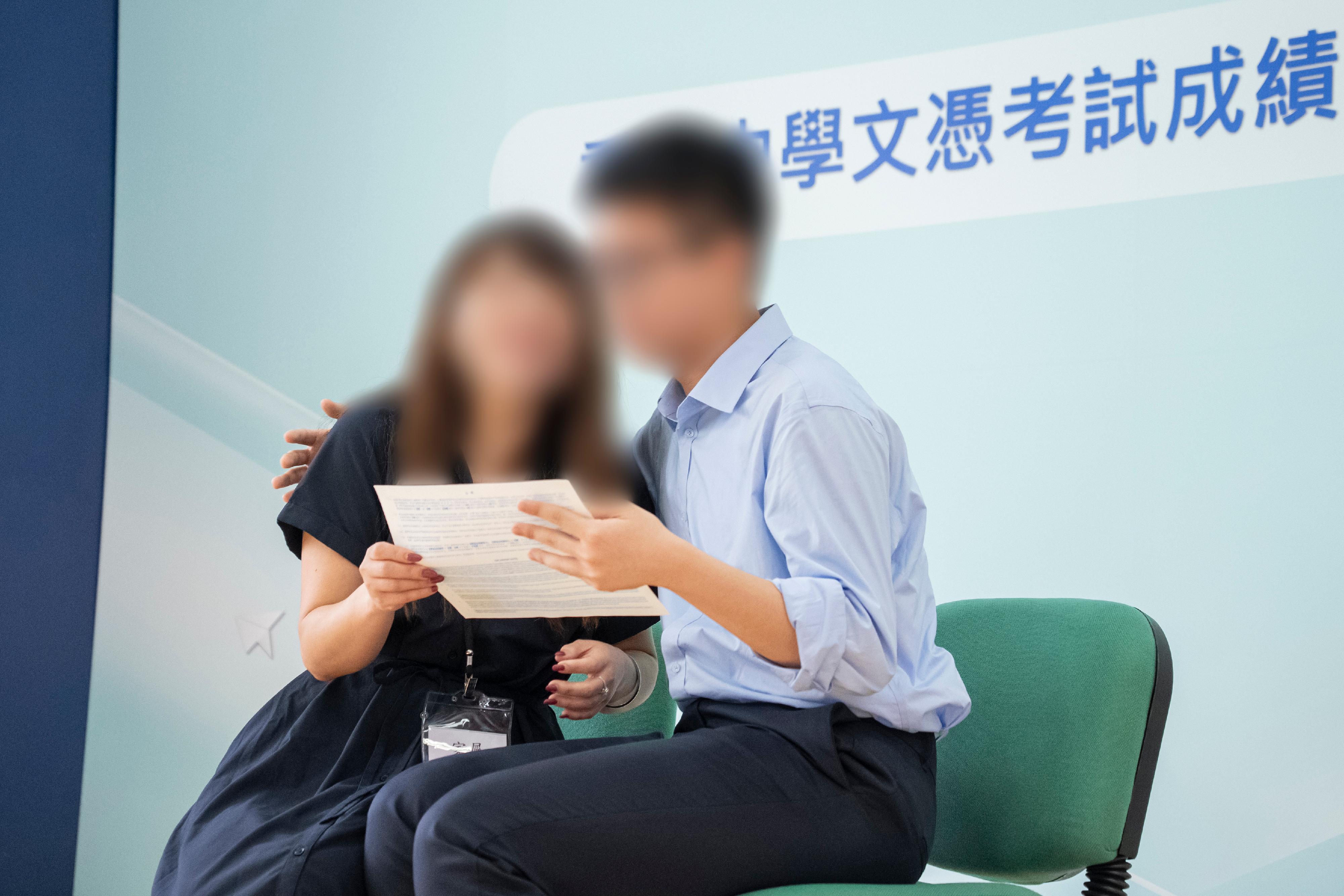 The results of the Hong Kong Diploma of Secondary Education Examination were released today (July 15). The Correctional Services Department held a press conference this morning at Sha Tsui Correctional Institution (STCI) to announce the satisfactory results obtained by young persons in custody who sat for the examination this year. Photo shows a candidate at STCI sharing his joy with his mother after achieving good results of scoring the highest 22 marks in the best five subjects and obtaining an "Attained" in Citizenship and Social Development.